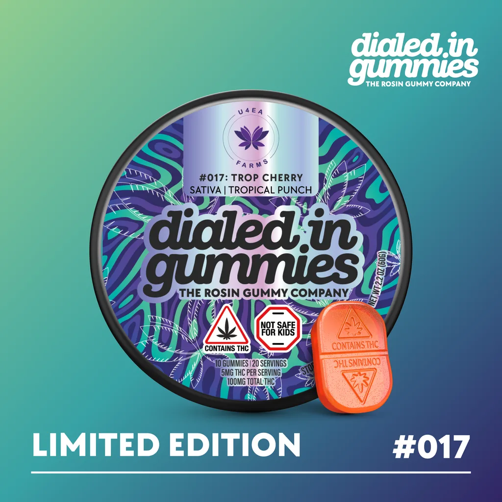 Purple and teal Dialed In Gummies limited edition tin labeled #017 Trop Cherry, sativa, tropical punch, with an orange gummy beside it.