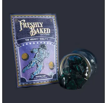 Purple Freshly Baked pouch with an astronaut illustration labeled Celestial, beside a glass jar of dark gem-shaped gummies.