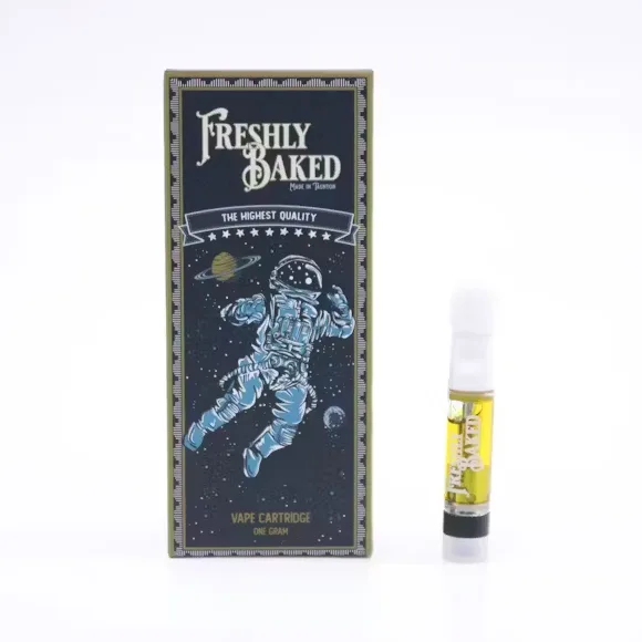 Navy Freshly Baked vape cartridge box with an astronaut illustration, beside a 510 cartridge with golden oil.