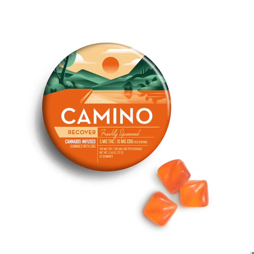 Round orange and green KIVA Camino Freshly Squeezed tin with a hillside landscape, next to three orange square gummies.