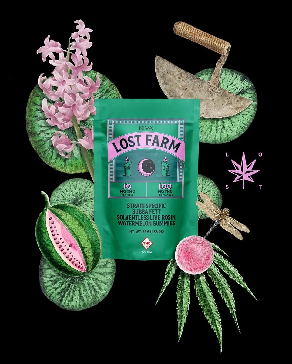 Green KIVA Lost Farm pouch surrounded by watermelon, lily pads, pink flowers, a dragonfly and a garden hoe on a black background.