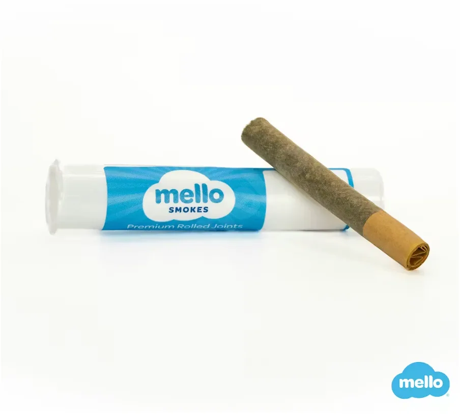 Clear tube with a blue Mello Smokes label beside a single pre-roll with a brown filter tip.
