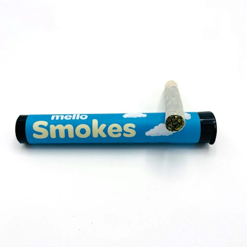 Blue Mello Smokes tube with cloud graphics and a pre-roll resting on top.