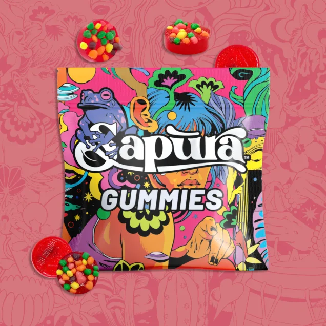 Colorful illustrated Sapura Gummies pouch on a pink background with red and multicolored gummies around it.