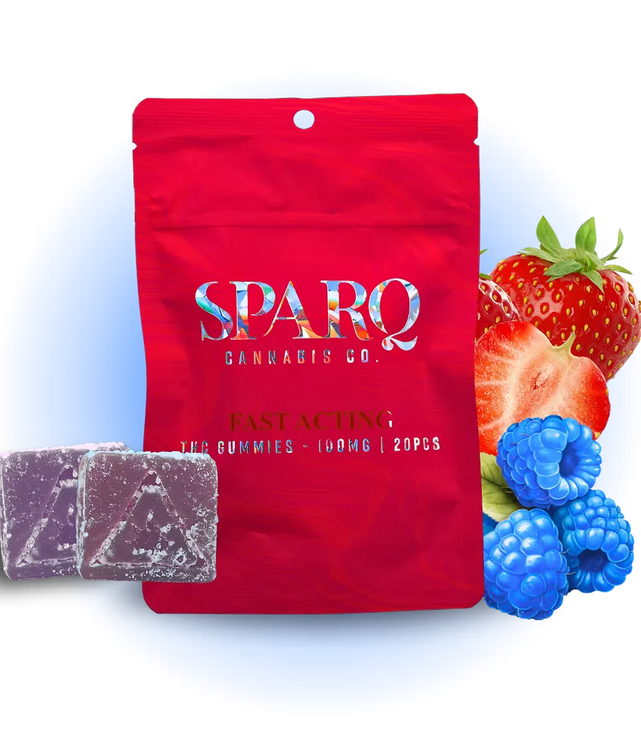 Red Sparq Cannabis Co. pouch with two square purple gummies, strawberries and blueberries beside it.