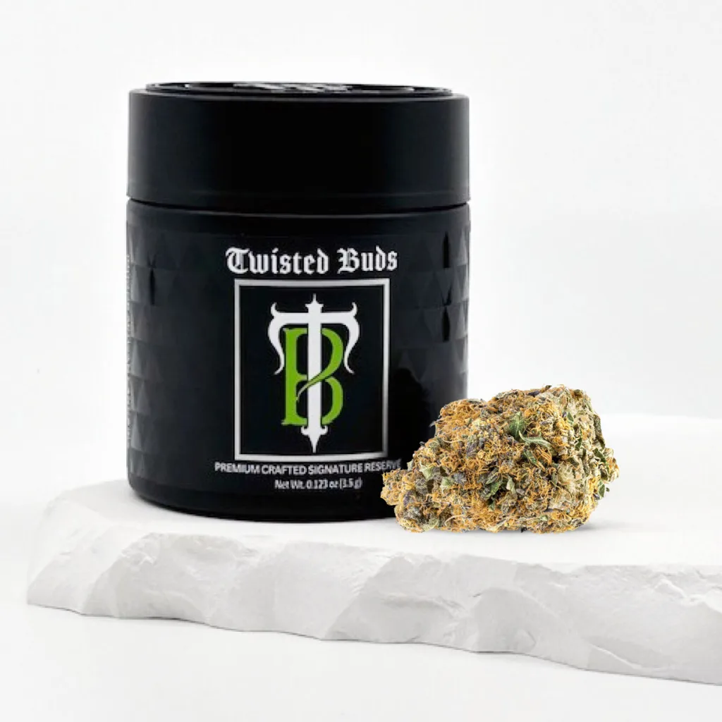 Black Twisted Buds jar with a green TB monogram label, next to a single cannabis bud on white stone.